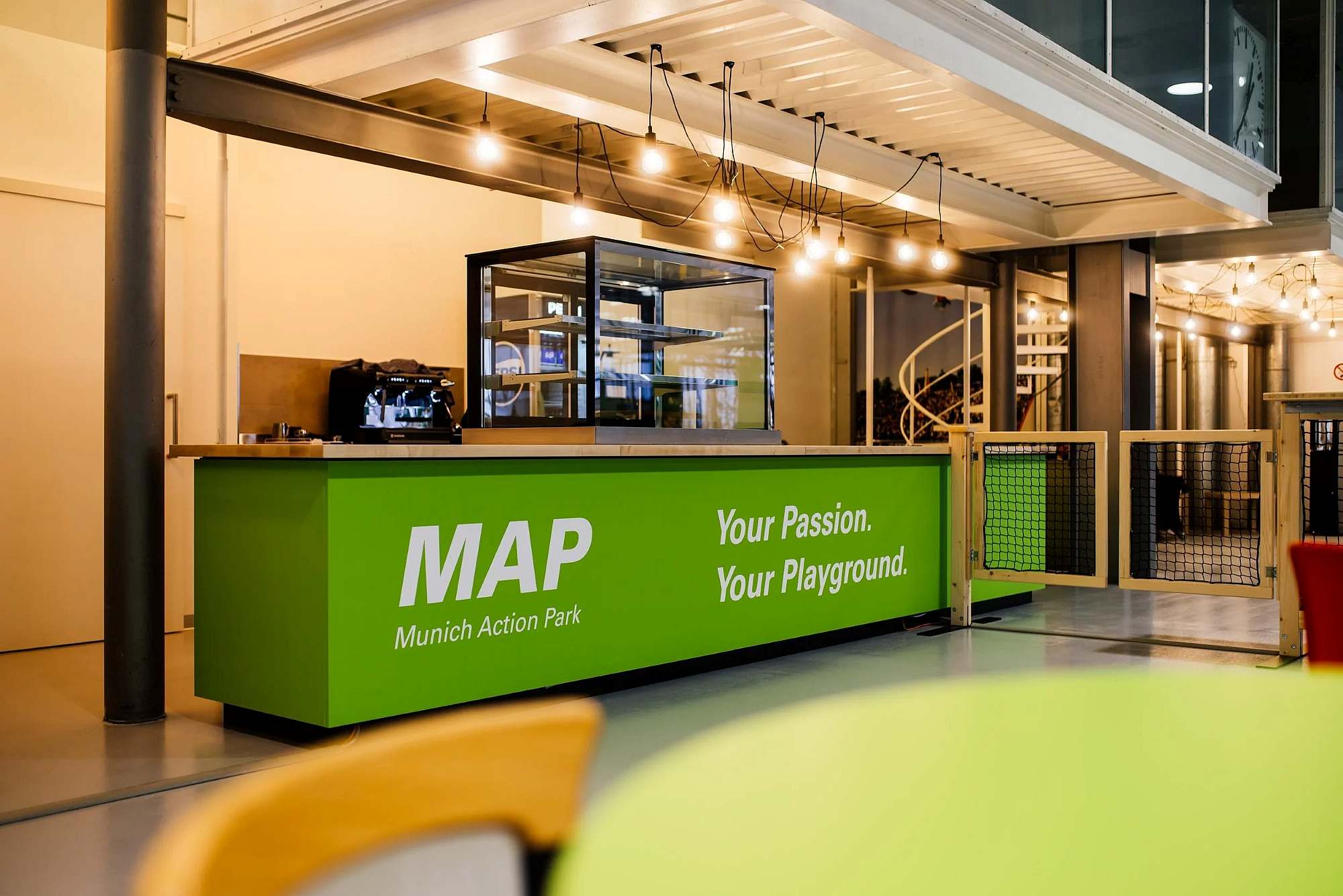 Counter with inscription MAP Munich Action Park Your Passion. Your Playground.