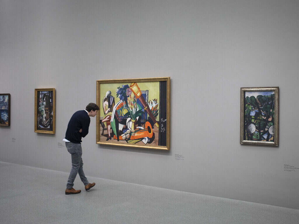 Man looking at paintings