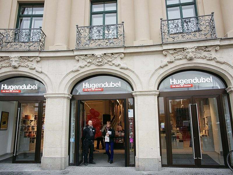 Exterior view of three large arches fitted with glass doors