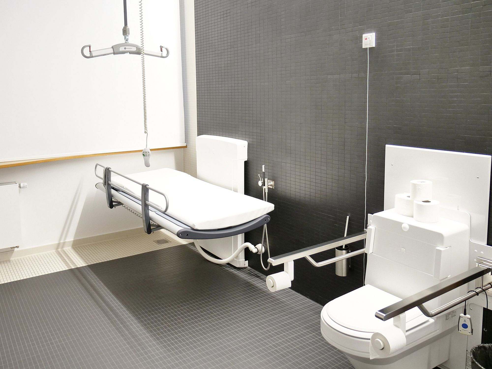 Interior of ‘Toilette für alle’ (toilet for all), WC with handles, height-adjustable, care bed also height-adjustable and ceiling lift