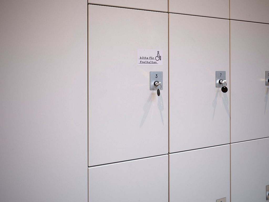 Lockers with the sign ‘Please keep this space free for people with disabilities’