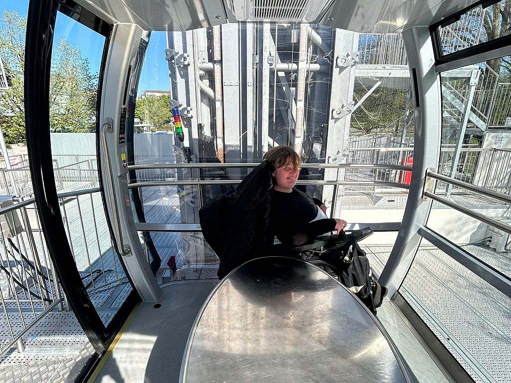Electric wheelchair user in the cabin