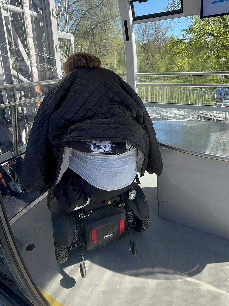 Electric wheelchair user manoeuvring in the cabin